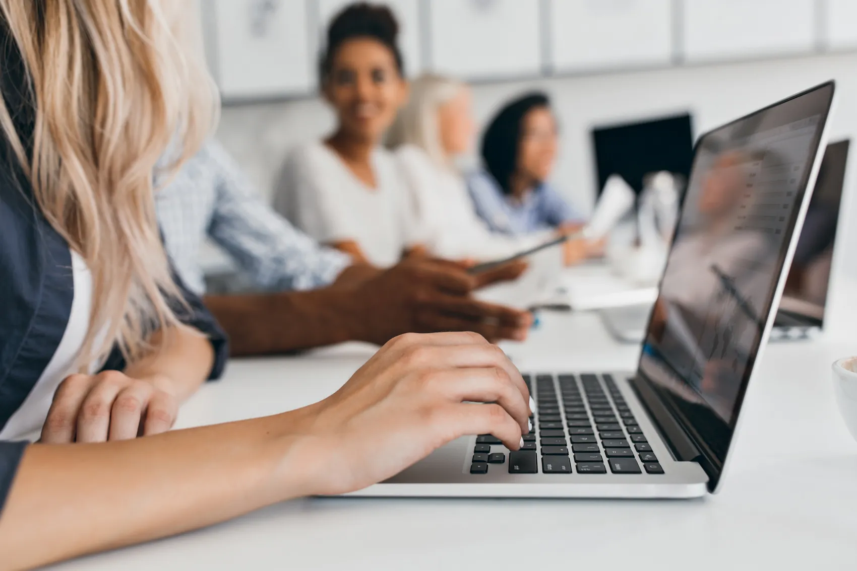 Blonde Woman With Elegant Hairstyle Typing Text Keyboard Office Indoor Portrait International Employees With Secretary Using Laptop